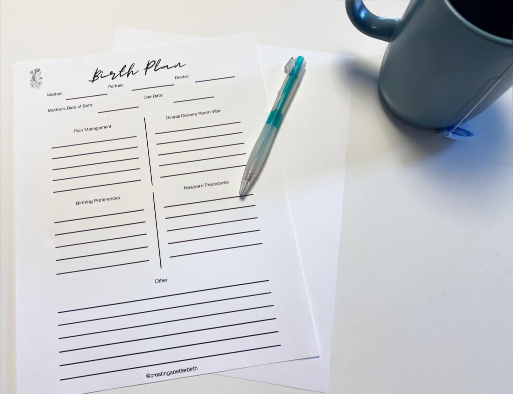 birth plan print out with pen lying bon top of it. mug in the corner