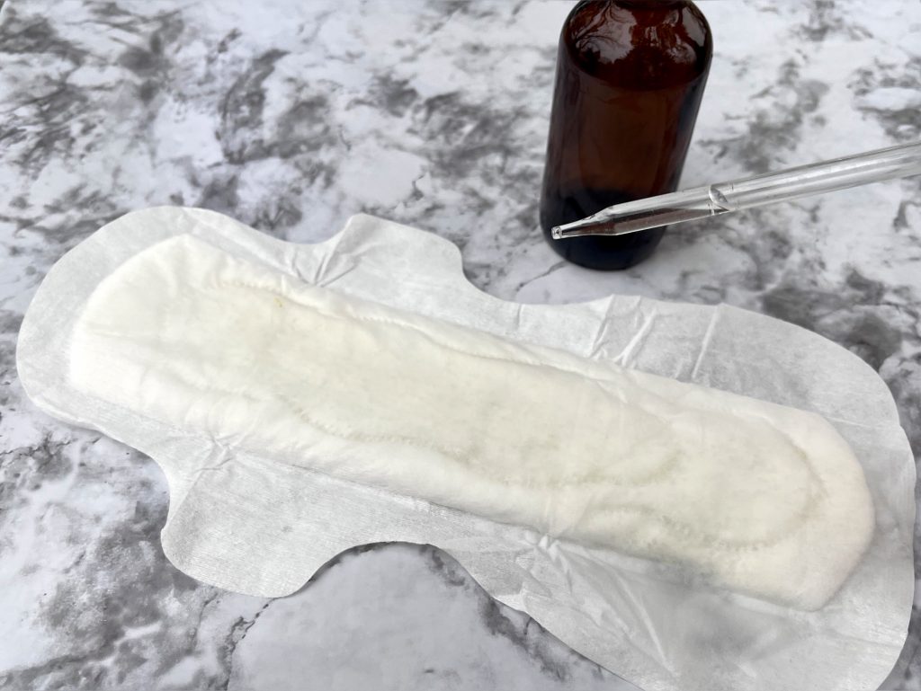 witch hazel being dripped onto an open pad padsicles